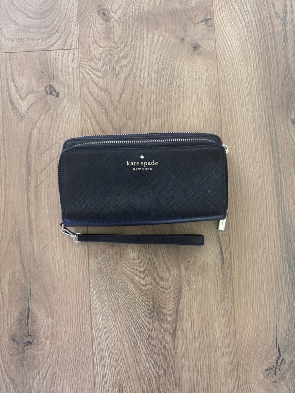 kate spade black and gold zip-around wristlet